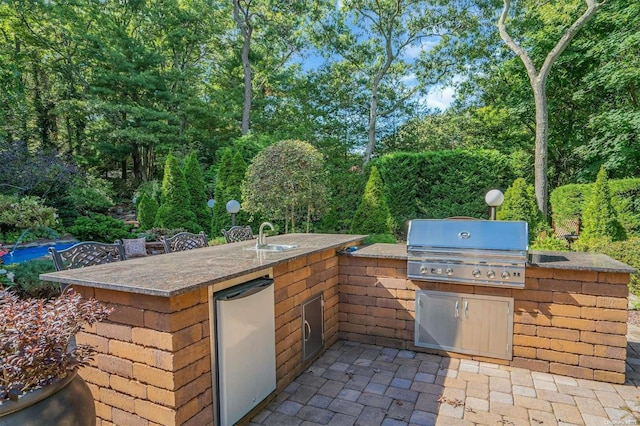 view of patio / terrace featuring area for grilling and sink