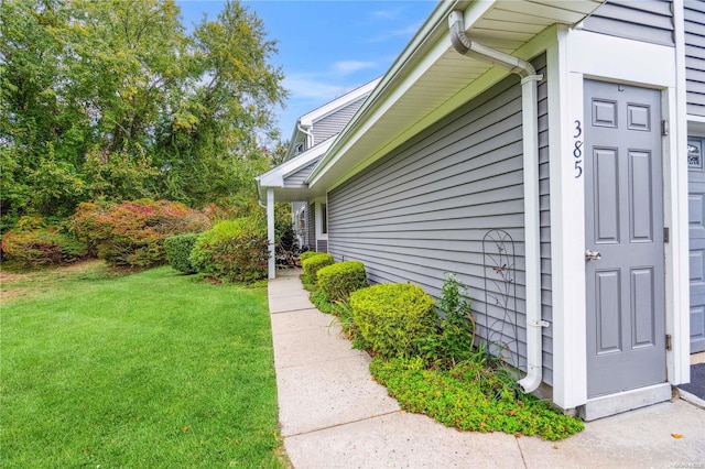 view of side of property with a yard