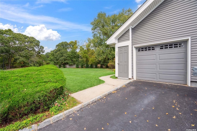 garage featuring a lawn