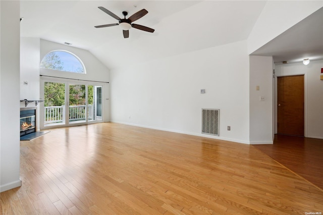 unfurnished living room with light wood-type flooring, ceiling fan, and lofted ceiling