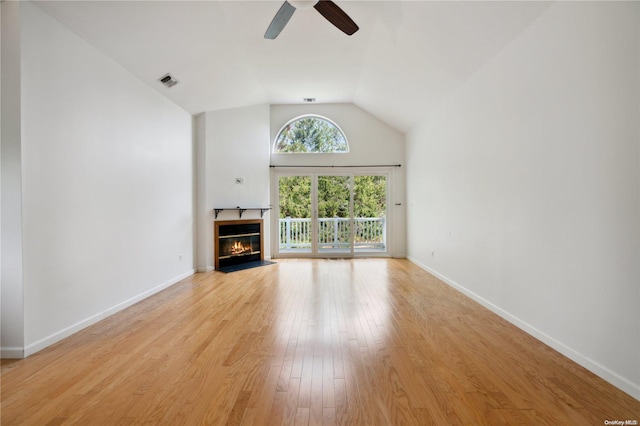 unfurnished living room featuring ceiling fan, lofted ceiling, and light hardwood / wood-style flooring