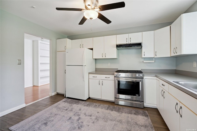 kitchen featuring electric range, white fridge, white cabinetry, and hardwood / wood-style flooring