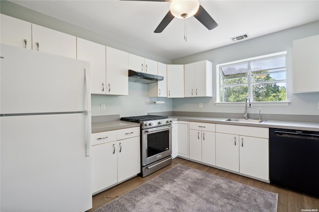 kitchen featuring white refrigerator, sink, stainless steel stove, black dishwasher, and white cabinetry