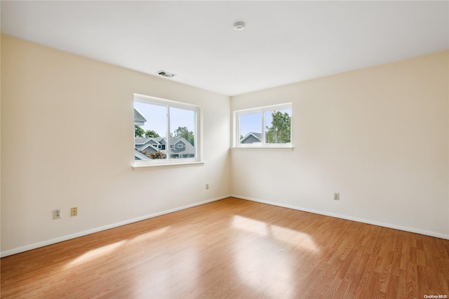 unfurnished room with hardwood / wood-style floors