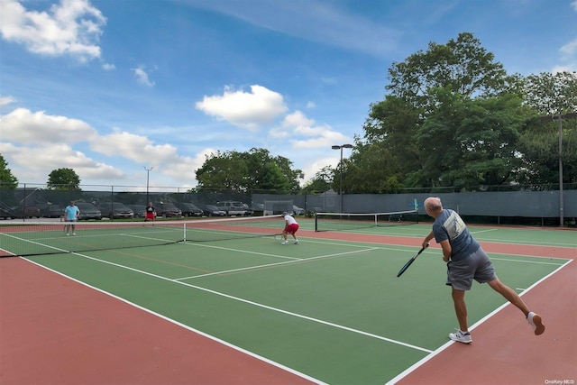 view of tennis court with basketball hoop