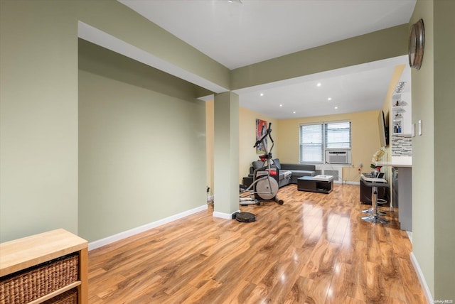 exercise area featuring light hardwood / wood-style flooring and cooling unit