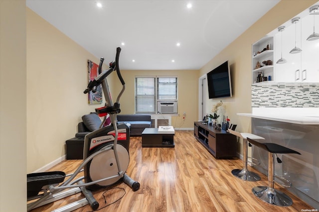 exercise room featuring light hardwood / wood-style flooring and cooling unit