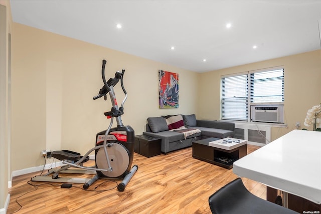 exercise area featuring cooling unit and light hardwood / wood-style flooring