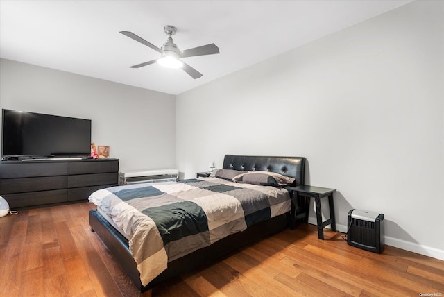 bedroom with hardwood / wood-style floors and ceiling fan