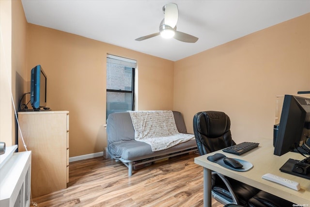 home office featuring light hardwood / wood-style floors and ceiling fan