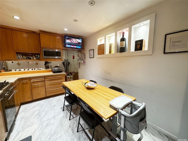 kitchen featuring black gas range and stainless steel microwave