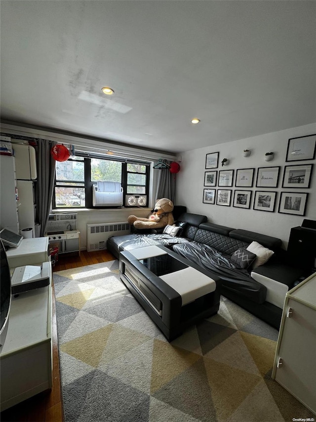 bedroom with hardwood / wood-style floors and radiator heating unit