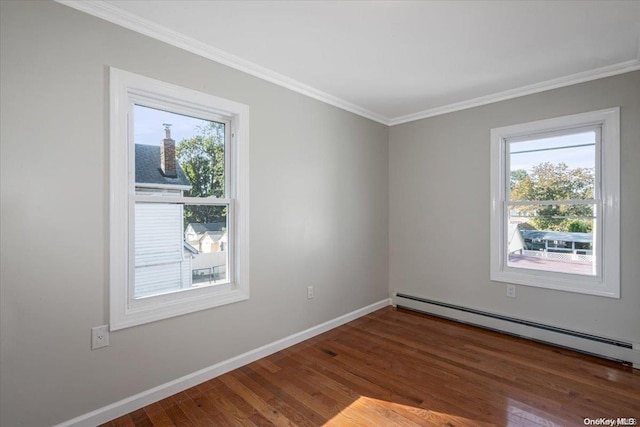 spare room featuring crown molding, dark wood-type flooring, and a baseboard radiator