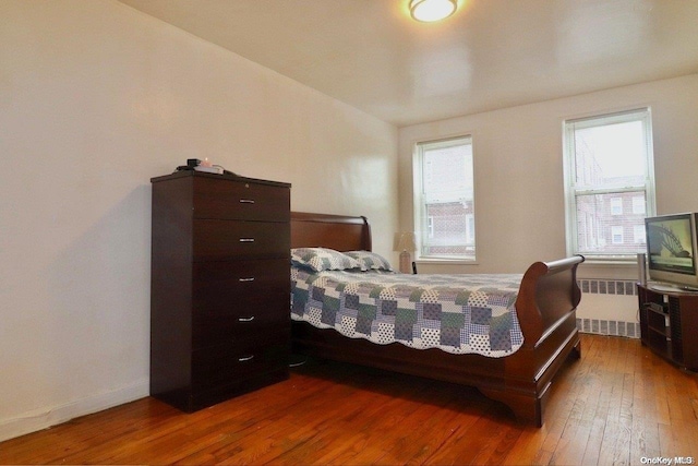 bedroom featuring radiator and dark wood-type flooring