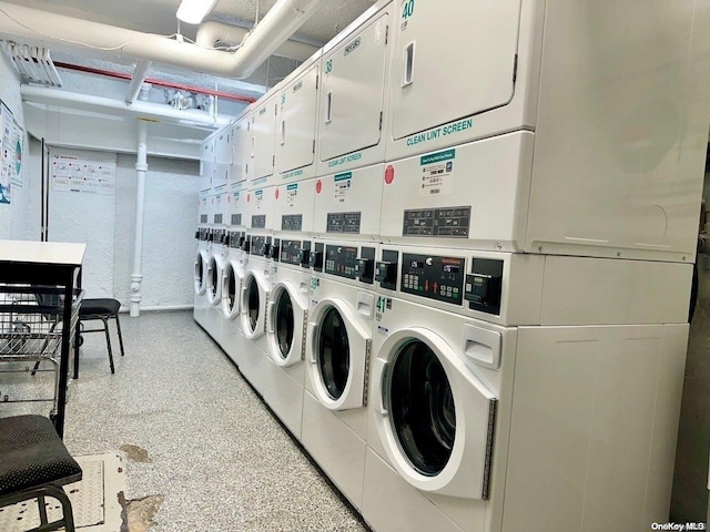 laundry room with stacked washing maching and dryer