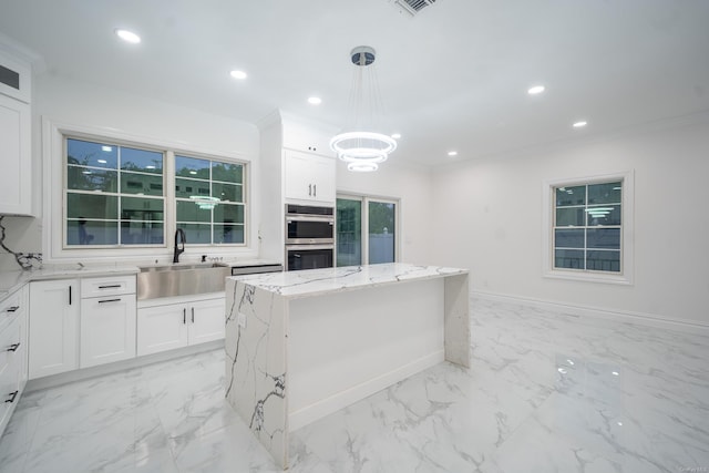 12 Hoover Ln, Bethpage, NY 11714 - kitchen with stainless steel double oven, light stone counters, white cabinetry, a chandelier, and a kitchen island