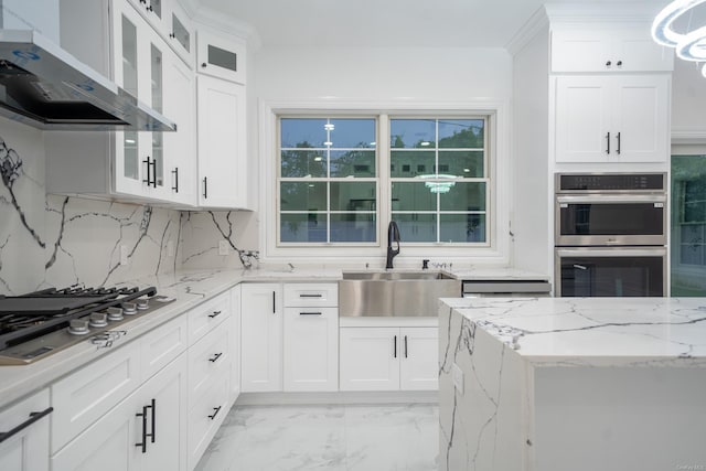12 Hoover Ln, Bethpage, NY 11714 - kitchen featuring wall chimney range hood, appliances with stainless steel finishes, tasteful backsplash, white cabinetry, and light marble finish flooring