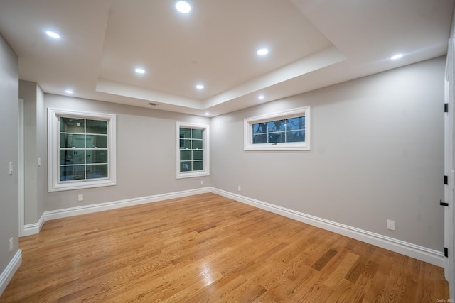 12 Hoover Ln, Bethpage, NY 11714 - empty room with light wood-type flooring, a tray ceiling, and recessed lighting