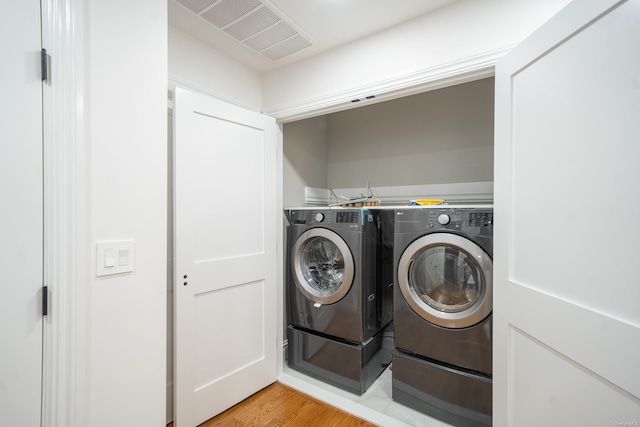12 Hoover Ln, Bethpage, NY 11714 - laundry room featuring washer and dryer and light wood finished floors
