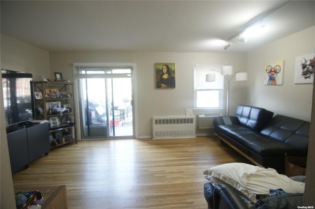 living room featuring light wood-type flooring and radiator