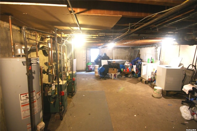 basement featuring washing machine and dryer and water heater