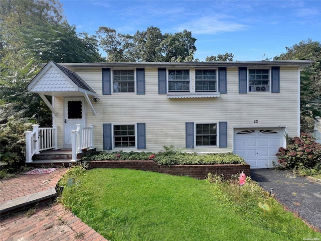 view of front facade with a front yard and a garage