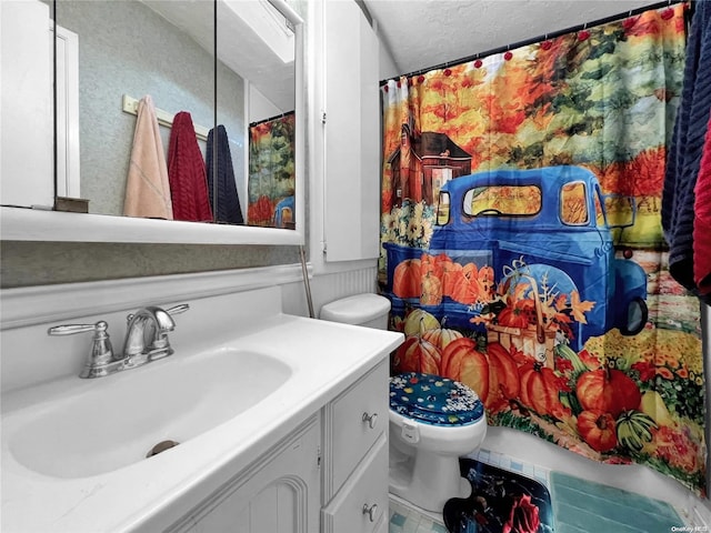 bathroom with vanity, a textured ceiling, and toilet