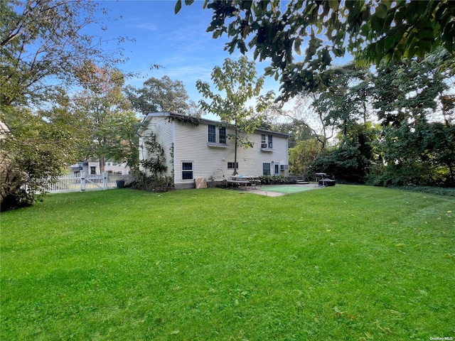 back of property featuring a yard and a patio