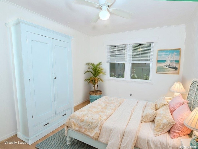 bedroom with ceiling fan and light wood-type flooring