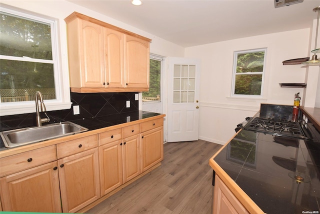 kitchen featuring tile countertops, backsplash, sink, hardwood / wood-style flooring, and light brown cabinetry