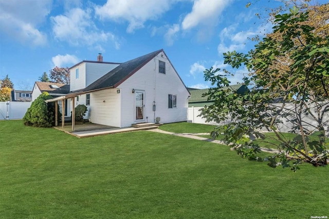 back of house featuring a lawn