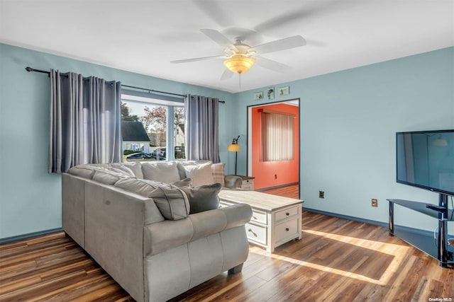 living room with dark hardwood / wood-style floors and ceiling fan