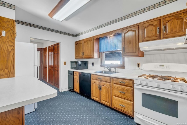 21 Fern Ter, West Babylon, NY 11704 - kitchen featuring black appliances, under cabinet range hood, light countertops, brown cabinetry, and dark carpet