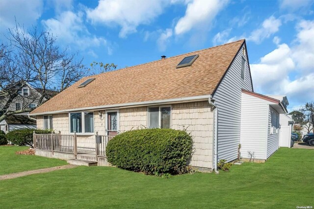 21 Fern Ter, West Babylon, NY 11704 - view of front of property with a front yard and a shingled roof