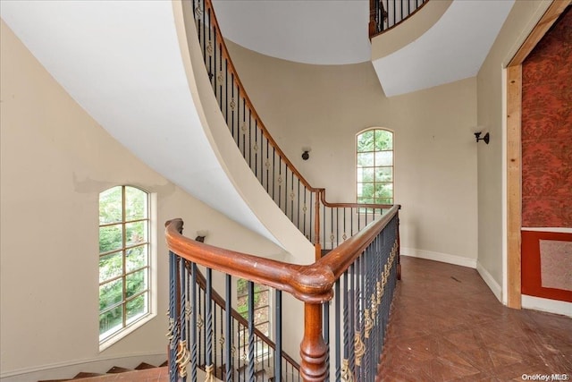 stairway with a high ceiling and a wealth of natural light