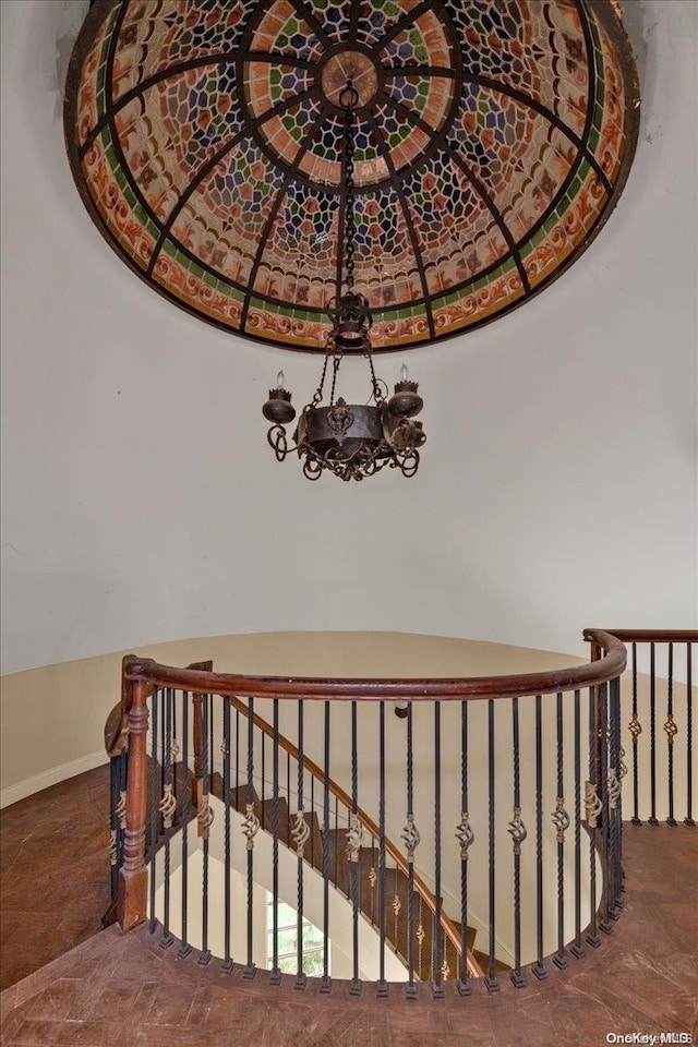 stairway featuring a chandelier