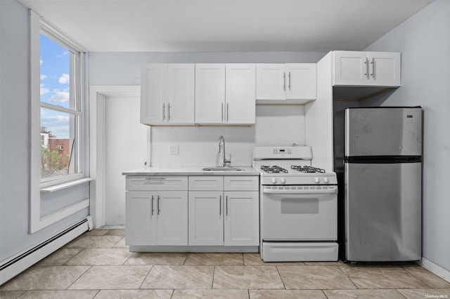 kitchen with stainless steel fridge, white cabinets, a baseboard heating unit, sink, and white range with gas stovetop