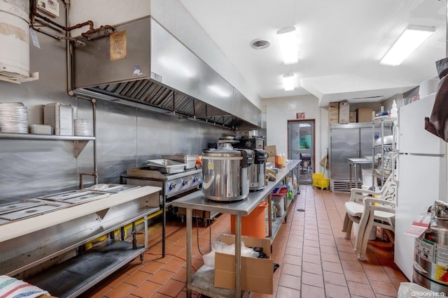 kitchen with wall chimney exhaust hood