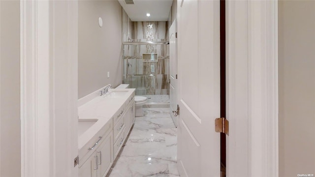 full bathroom with marble finish floor, double vanity, toilet, a stall shower, and a sink