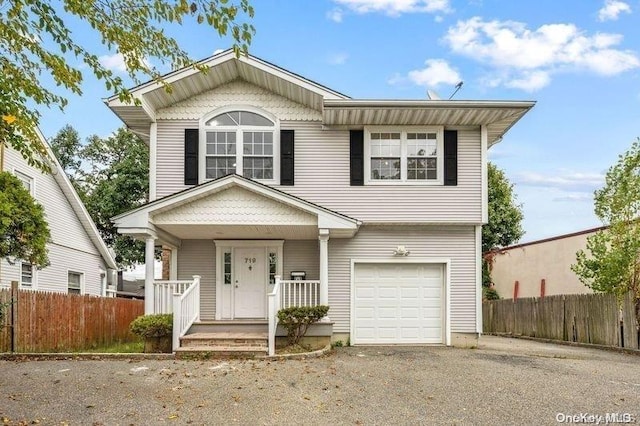 view of front of house with covered porch and a garage