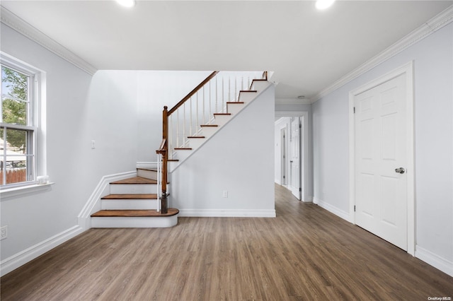 staircase with wood-type flooring and crown molding