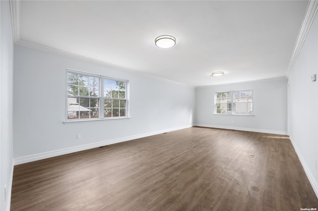 spare room with dark hardwood / wood-style flooring and crown molding