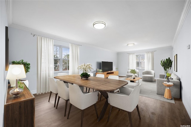 dining area featuring wood-type flooring and crown molding