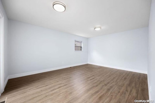 unfurnished room with wood-type flooring