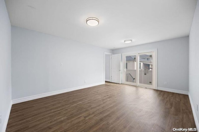 unfurnished room featuring dark hardwood / wood-style flooring