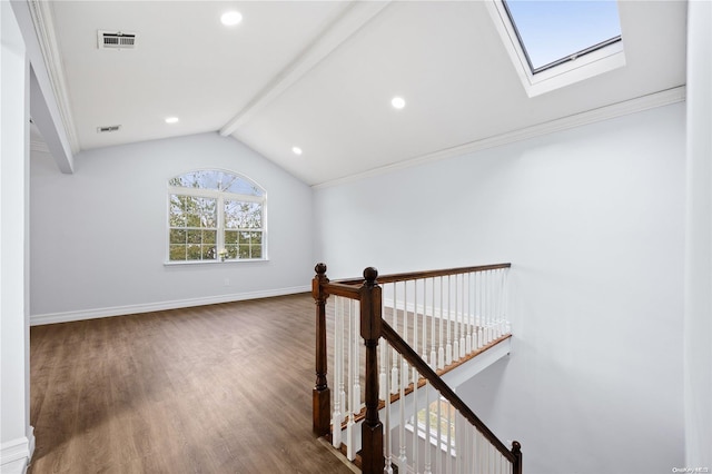 corridor featuring hardwood / wood-style flooring, lofted ceiling with skylight, and crown molding