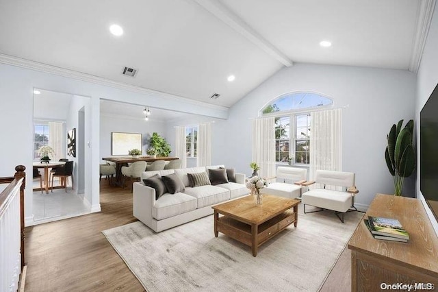 living room with hardwood / wood-style floors, vaulted ceiling with beams, and crown molding