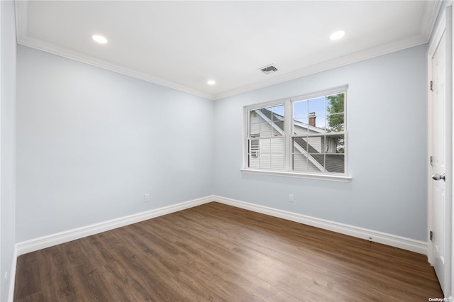 spare room with wood-type flooring and crown molding