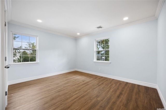 unfurnished room with wood-type flooring, ornamental molding, and a wealth of natural light