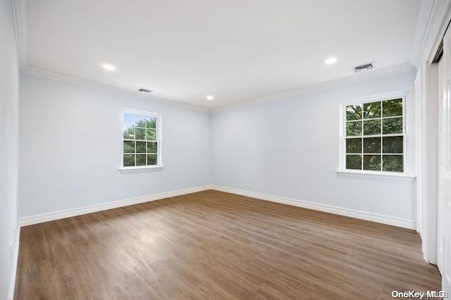 unfurnished room featuring crown molding and dark wood-type flooring